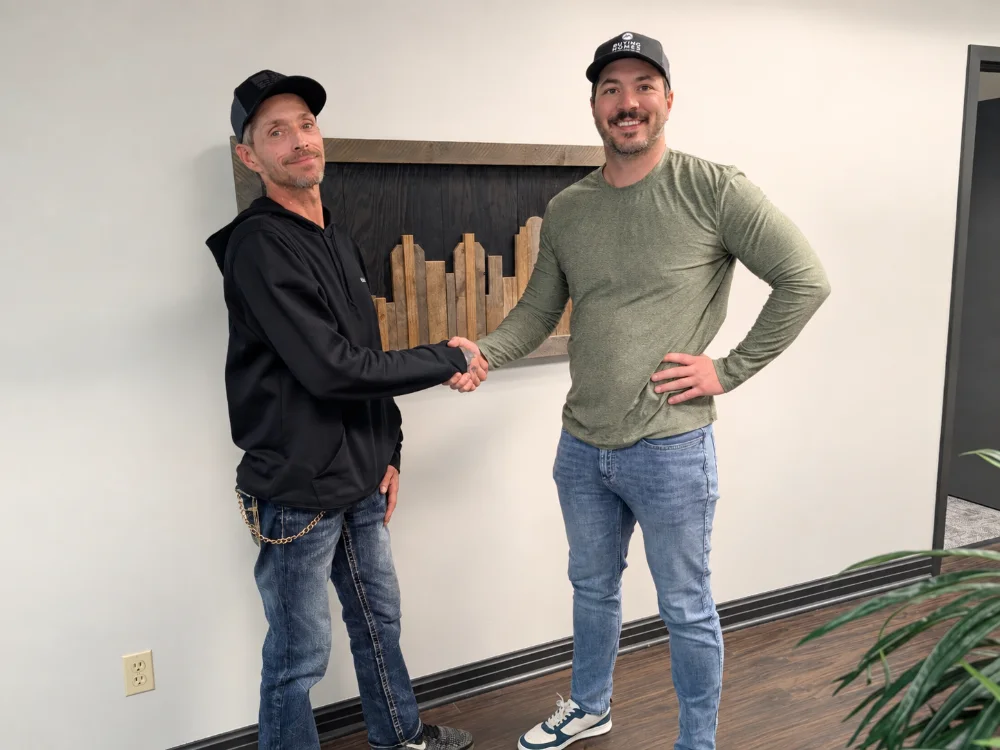 Dan shaking hands with a seller after closing