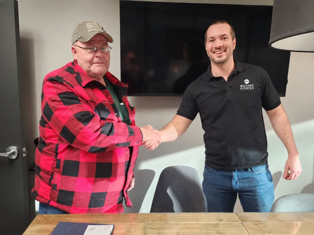 Dan shaking hands with a seller at the title company
