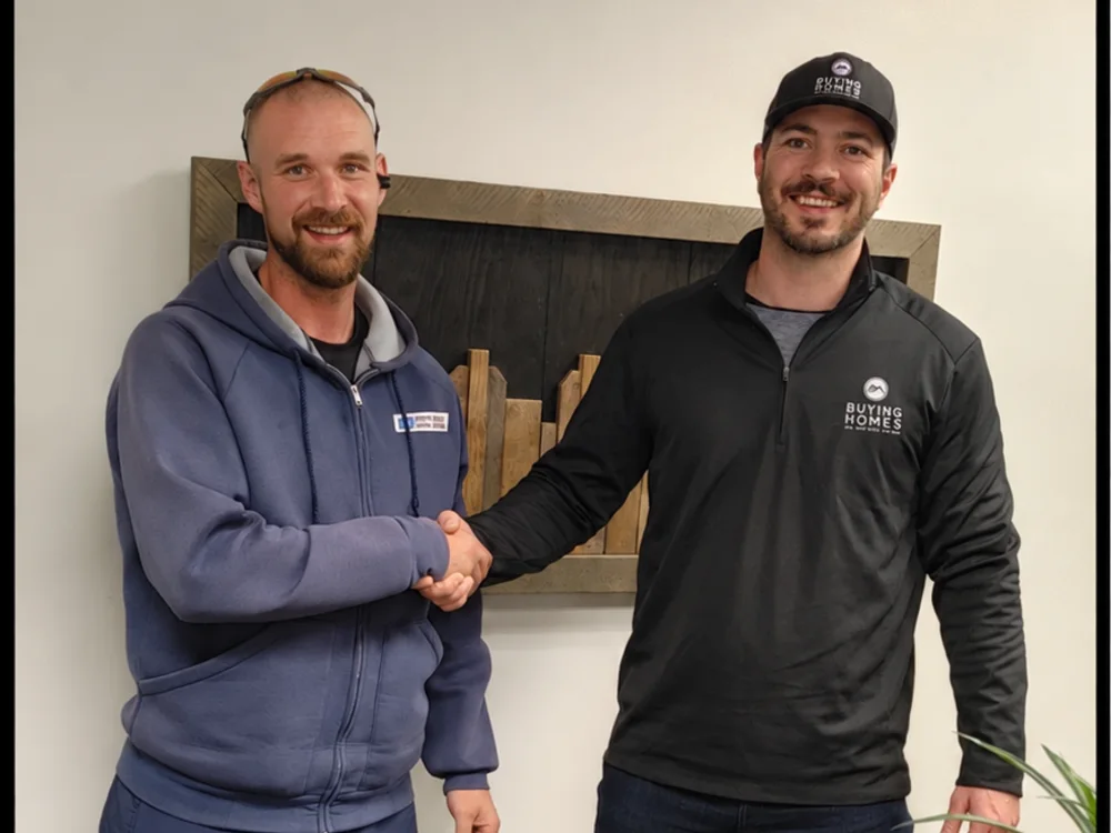 Dan shaking hands with a seller after closing