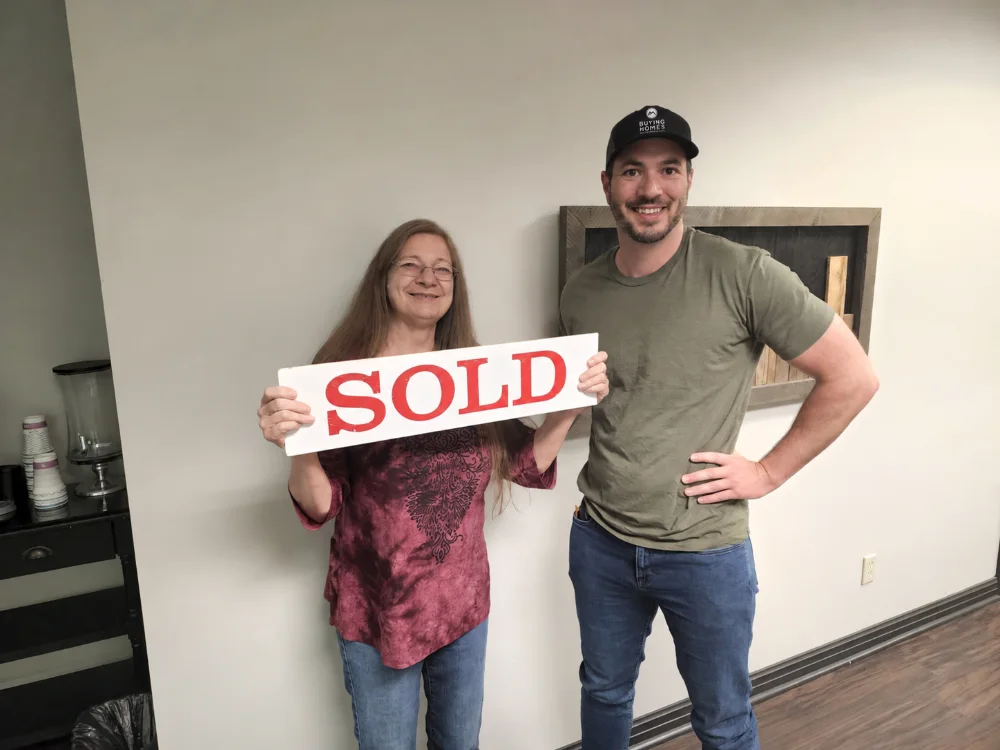 Dan with a seller holding a SOLD sign